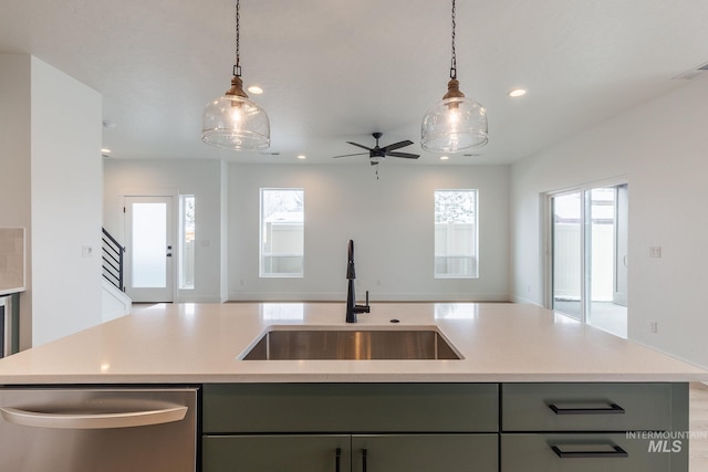 kitchen featuring open floor plan, gray cabinets, a sink, and decorative light fixtures