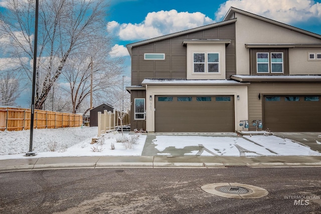 view of front of house featuring fence and an attached garage