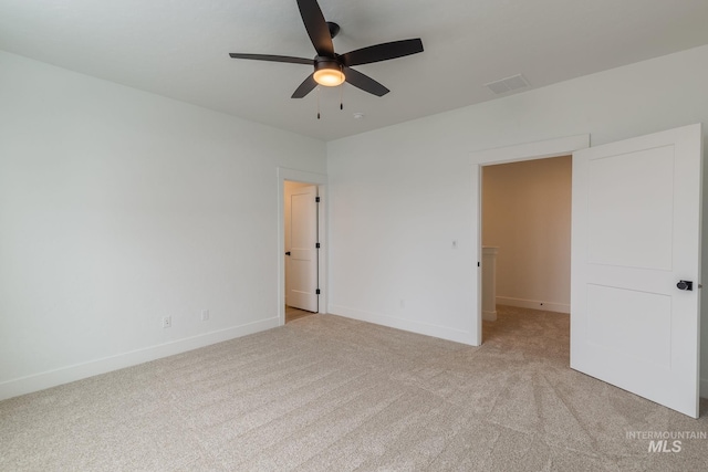 unfurnished bedroom featuring light carpet, ceiling fan, visible vents, and baseboards