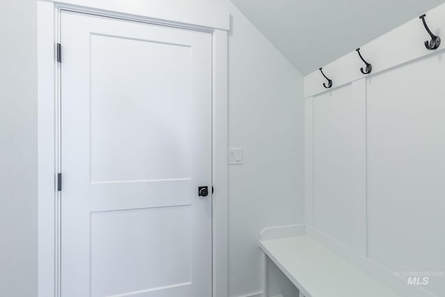 mudroom featuring vaulted ceiling