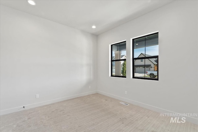 empty room with light colored carpet