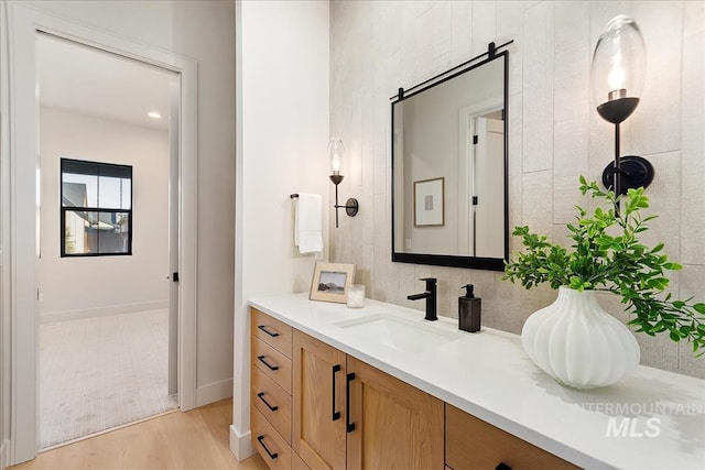 bathroom with hardwood / wood-style floors and vanity