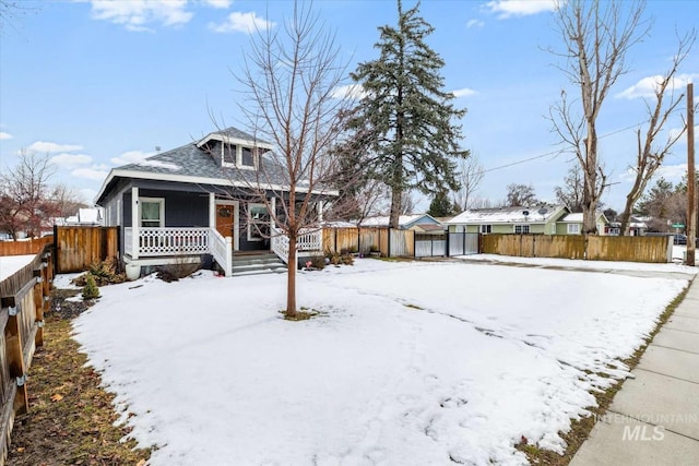 view of front of property featuring a porch and fence