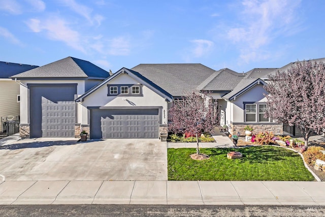 2133 N Star Garnet Ave, Kuna, ID 83634 - view of front of property with stone siding, stucco siding, driveway, and a garage