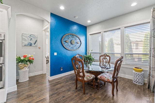 2133 N Star Garnet Ave, Kuna, ID 83634 - dining space featuring dark wood-style flooring, baseboards, recessed lighting, arched walkways, and an accent wall