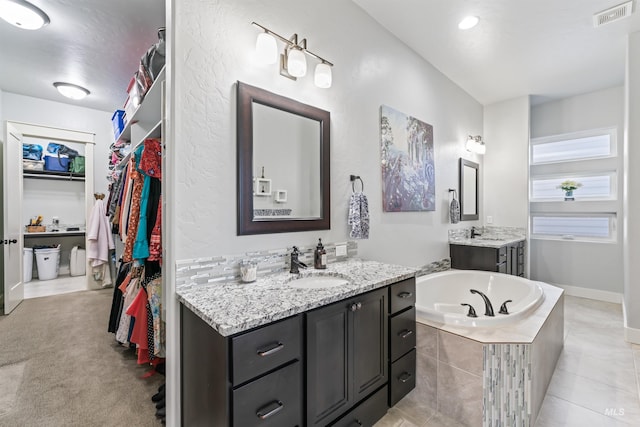 2133 N Star Garnet Ave, Kuna, ID 83634 - full bathroom featuring a garden tub, a walk in closet, and two vanities