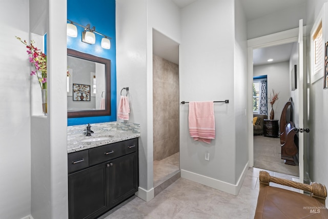 2133 N Star Garnet Ave, Kuna, ID 83634 - full bathroom with walk in shower, vanity, baseboards, and tile patterned flooring