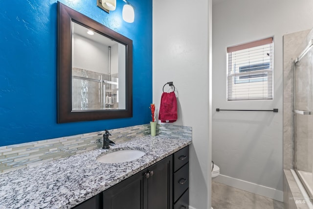 2133 N Star Garnet Ave, Kuna, ID 83634 - full bathroom featuring a tile shower, baseboards, vanity, and toilet