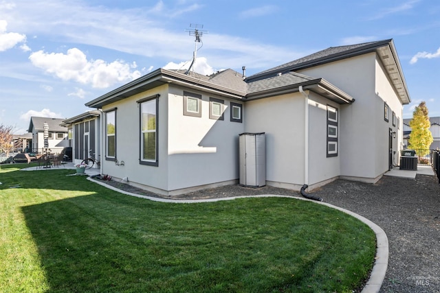 2133 N Star Garnet Ave, Kuna, ID 83634 - rear view of property featuring stucco siding, a yard, central air condition unit, and a patio area