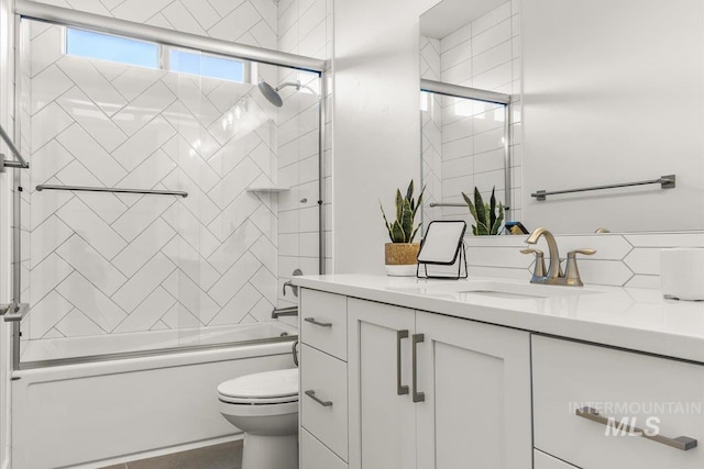 1279 W Ultar, Nampa, ID 83686 - bathroom featuring toilet, tasteful backsplash, bath / shower combo with glass door, and vanity