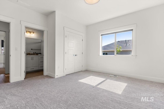 1279 W Ultar, Nampa, ID 83686 - unfurnished bedroom with visible vents, baseboards, a closet, carpet, and ensuite bath