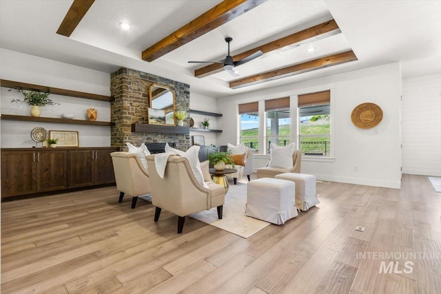 1279 W Ultar, Nampa, ID 83686 - living room featuring a stone fireplace, a ceiling fan, light wood-style flooring, and beam ceiling