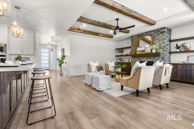 1279 W Ultar, Nampa, ID 83686 - living room featuring light wood-style floors, baseboards, ceiling fan with notable chandelier, and beamed ceiling