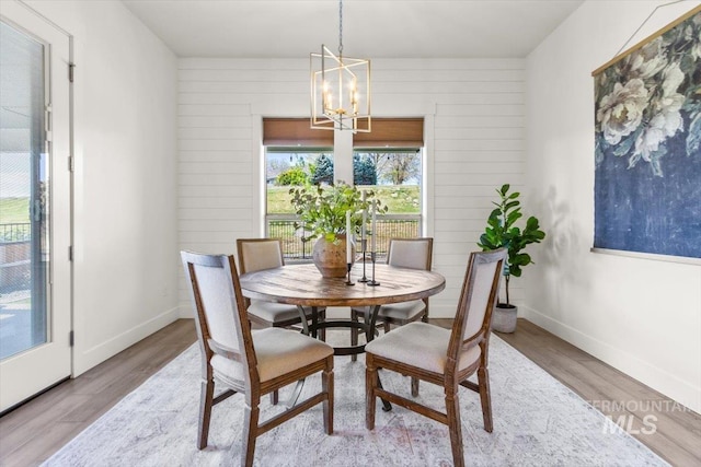 1279 W Ultar, Nampa, ID 83686 - dining space with wood walls, wood finished floors, and a chandelier