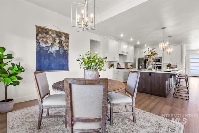 1279 W Ultar, Nampa, ID 83686 - dining space featuring an inviting chandelier, light wood-style flooring, and baseboards