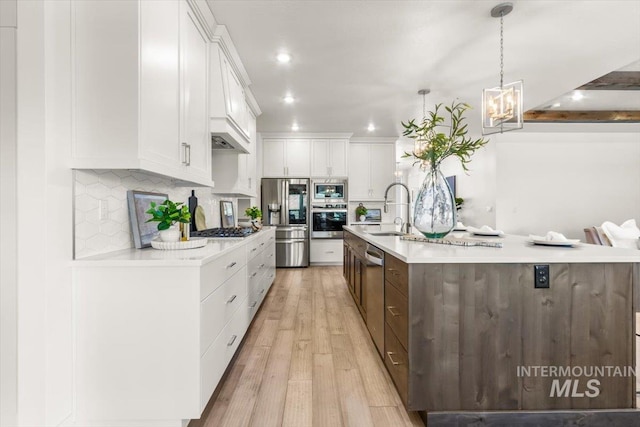 1279 W Ultar, Nampa, ID 83686 - kitchen featuring decorative backsplash, light countertops, white cabinetry, a sink, and appliances with stainless steel finishes