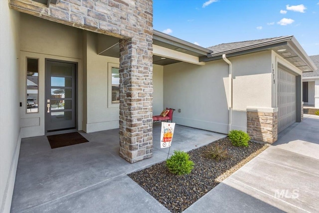 1279 W Ultar, Nampa, ID 83686 - doorway to property with an attached garage, stone siding, and stucco siding