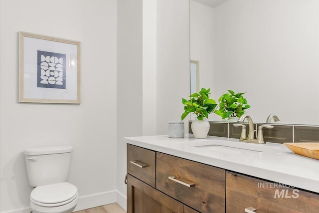 1279 W Ultar, Nampa, ID 83686 - bathroom with toilet, baseboards, wood finished floors, and vanity