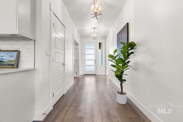 1279 W Ultar, Nampa, ID 83686 - doorway to outside featuring baseboards, wood finished floors, and a notable chandelier