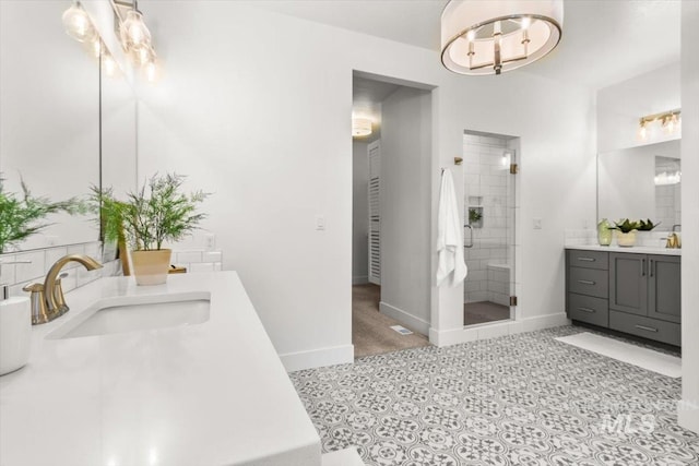 1279 W Ultar, Nampa, ID 83686 - bathroom featuring tile patterned flooring, a stall shower, two vanities, a sink, and baseboards