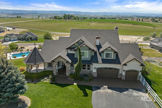 birds eye view of property with a rural view