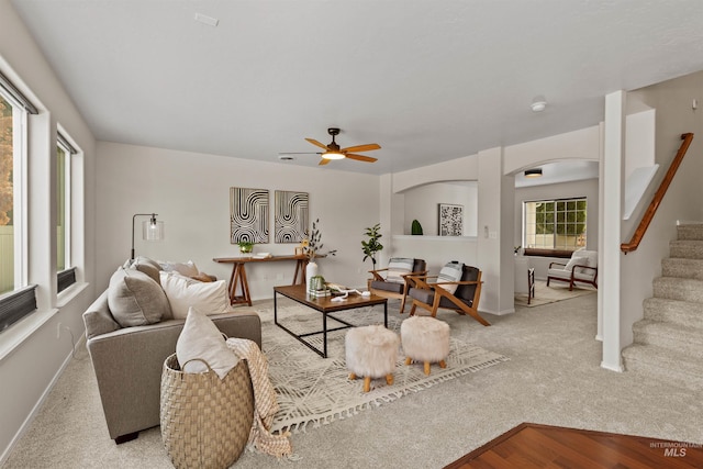 11422 W Darkwood St, Star, ID 83669 - living room with arched walkways, stairway, baseboards, and a ceiling fan
