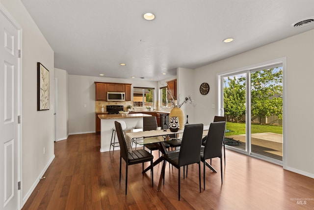 11422 W Darkwood St, Star, ID 83669 - dining space with dark wood finished floors, baseboards, and recessed lighting
