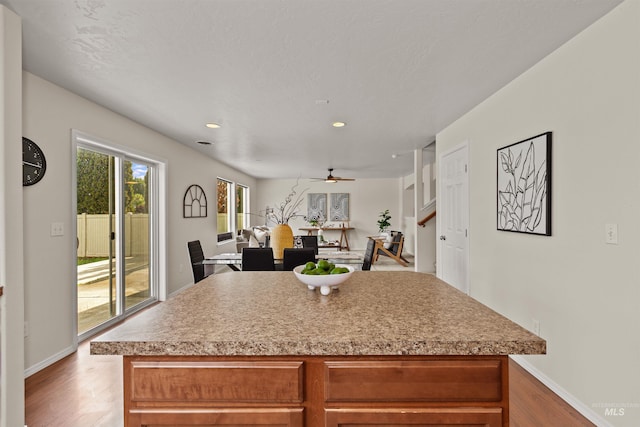 11422 W Darkwood St, Star, ID 83669 - kitchen with wood finished floors, ceiling fan, baseboards, and recessed lighting