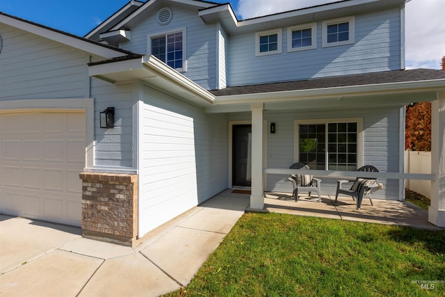 11422 W Darkwood St, Star, ID 83669 - property entrance featuring a shingled roof, an attached garage, and a porch