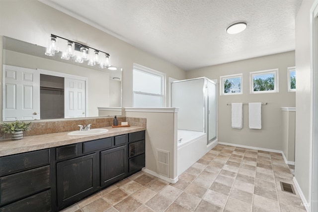 5217 Weston Ave, Caldwell, ID 83607 - full bath featuring a shower stall, healthy amount of natural light, vanity, a textured ceiling, and a tub