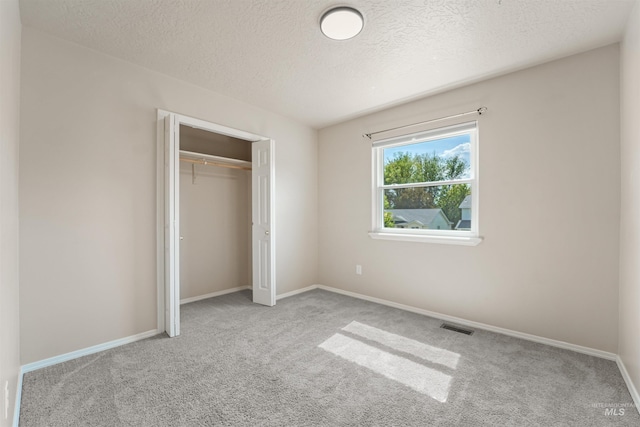 5217 Weston Ave, Caldwell, ID 83607 - unfurnished bedroom featuring carpet flooring, a textured ceiling, and a closet