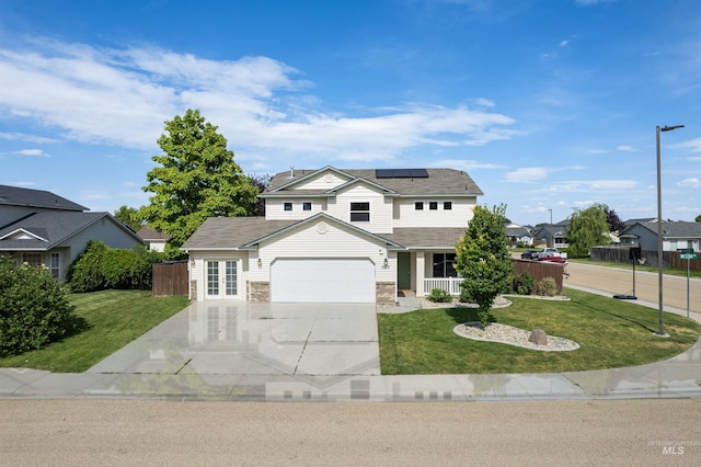 5217 Weston Ave, Caldwell, ID 83607 - traditional home with driveway, roof mounted solar panels, french doors, a garage, and a residential view