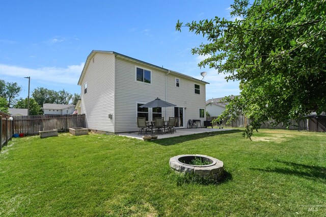 5217 Weston Ave, Caldwell, ID 83607 - back of house featuring a patio, a fenced backyard, and an outdoor fire pit