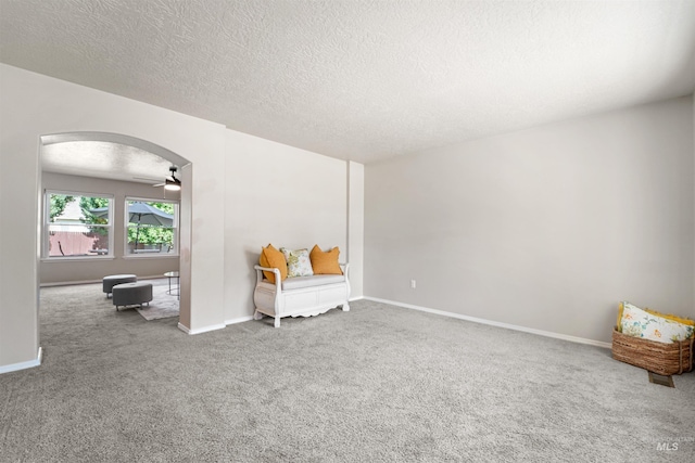5217 Weston Ave, Caldwell, ID 83607 - sitting room featuring carpet flooring, arched walkways, and a textured ceiling