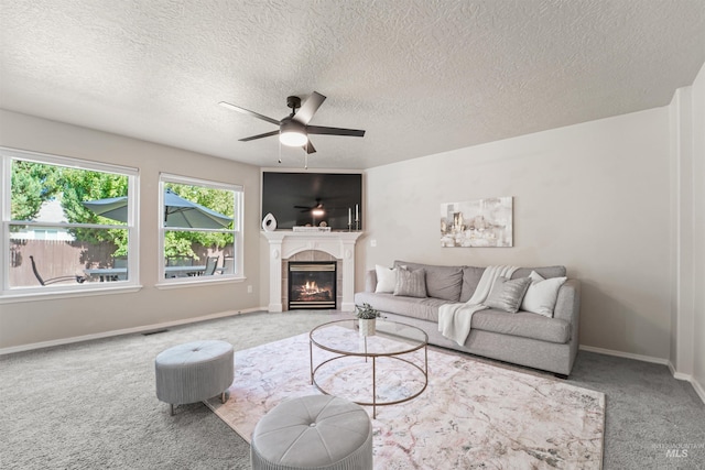 5217 Weston Ave, Caldwell, ID 83607 - carpeted living room featuring a ceiling fan, a tile fireplace, and a textured ceiling