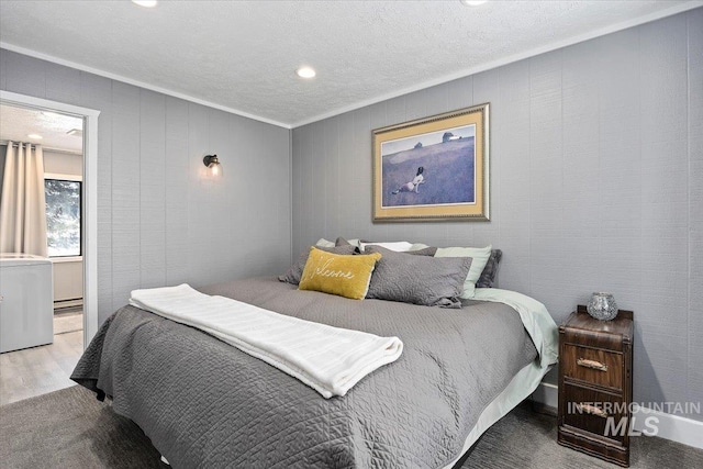 bedroom featuring crown molding, hardwood / wood-style floors, a textured ceiling, and a baseboard heating unit