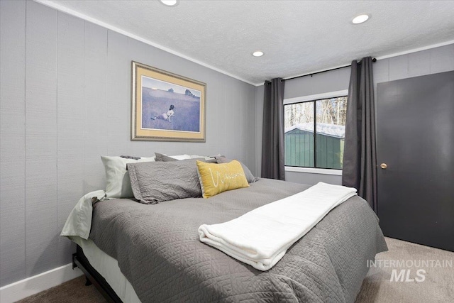 carpeted bedroom featuring a textured ceiling