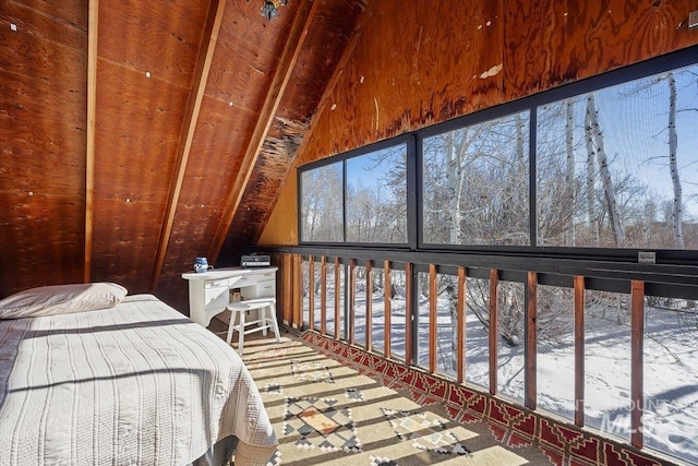 unfurnished bedroom with multiple windows and vaulted ceiling