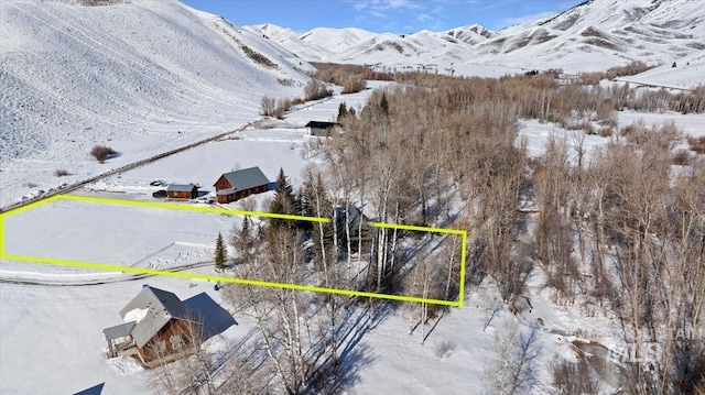 snowy aerial view with a mountain view