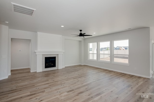8172 E Red Horse St, Nampa, ID 83687 - unfurnished living room with a ceiling fan, light wood-style floors, baseboards, a tiled fireplace, and recessed lighting