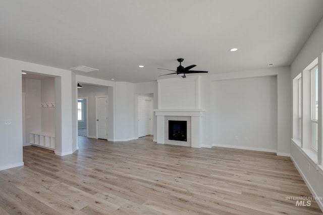 8172 E Red Horse St, Nampa, ID 83687 - unfurnished living room featuring ceiling fan, light wood finished floors, recessed lighting, a tiled fireplace, and baseboards