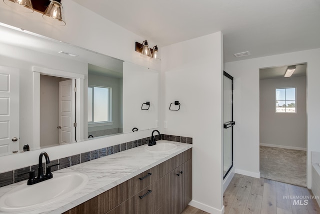 8172 E Red Horse St, Nampa, ID 83687 - full bath with a stall shower, wood finished floors, double vanity, and baseboards