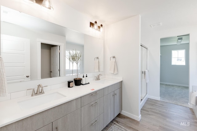 8172 E Red Horse St, Nampa, ID 83687 - full bath with a shower stall, baseboards, wood finished floors, and double vanity