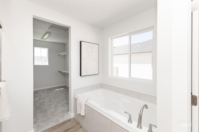 8172 E Red Horse St, Nampa, ID 83687 - bathroom with a garden tub, baseboards, and wood finished floors