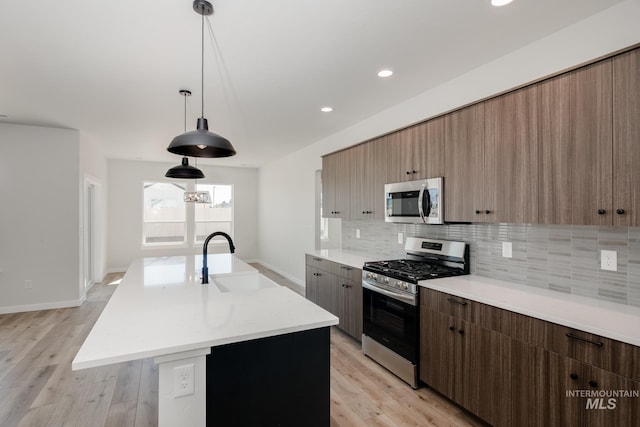 8172 E Red Horse St, Nampa, ID 83687 - kitchen with appliances with stainless steel finishes, a sink, modern cabinets, tasteful backsplash, and light countertops