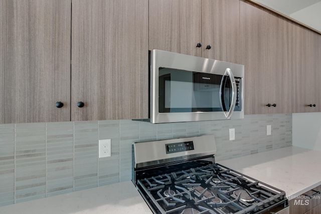 8172 E Red Horse St, Nampa, ID 83687 - kitchen featuring appliances with stainless steel finishes, backsplash, modern cabinets, and light brown cabinets