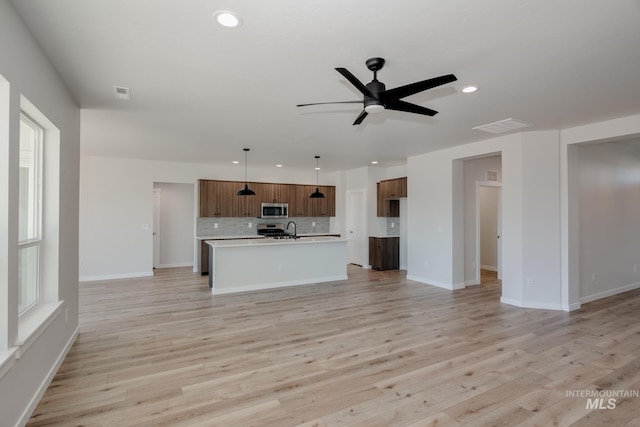 8172 E Red Horse St, Nampa, ID 83687 - unfurnished living room with recessed lighting, ceiling fan, light wood-style flooring, baseboards, and plenty of natural light