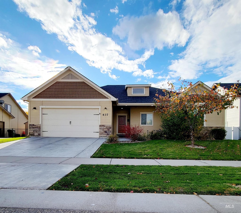 craftsman-style house featuring a front yard and a garage