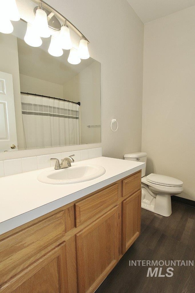 1300 Diamond Ct, Nampa, ID 83686 - full bathroom featuring vanity, toilet, wood finished floors, and a shower with curtain