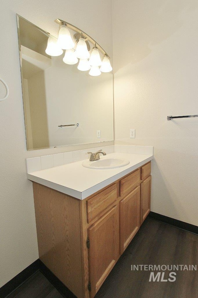 1300 Diamond Ct, Nampa, ID 83686 - bathroom featuring vanity, wood finished floors, and baseboards